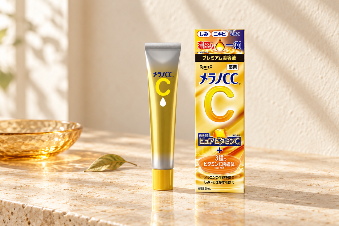 Rohto Melano CC Premium Essence tube and Japanese box on a warm ivory vanity