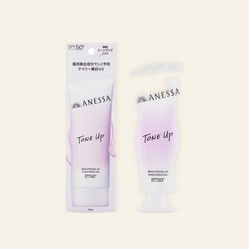 Anessa Tone Up Brightening UV Sunscreen SPF 50+ on a warm ivory background